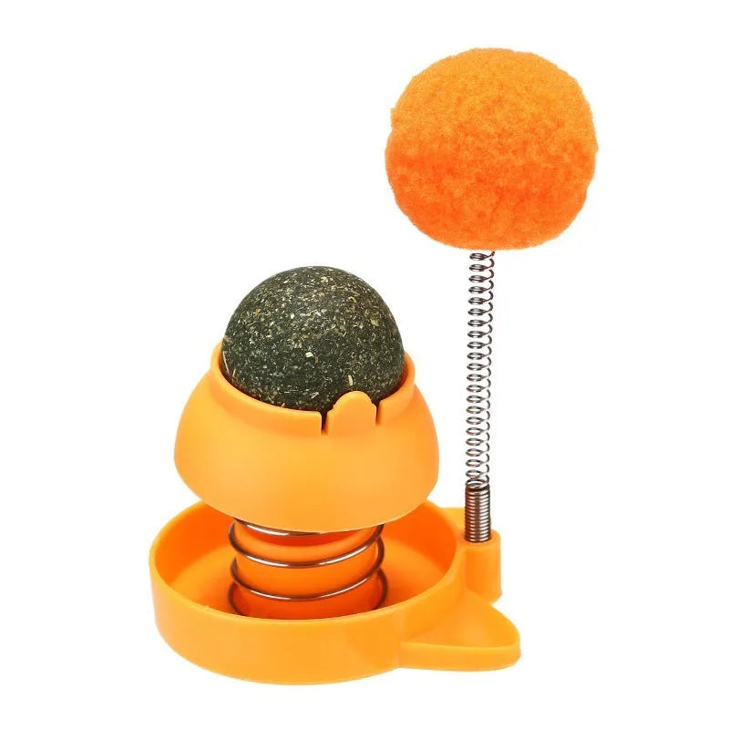 Lucky cat licking mint ball cat toy in blue, orange, and pink colours measuring 55mm diameter