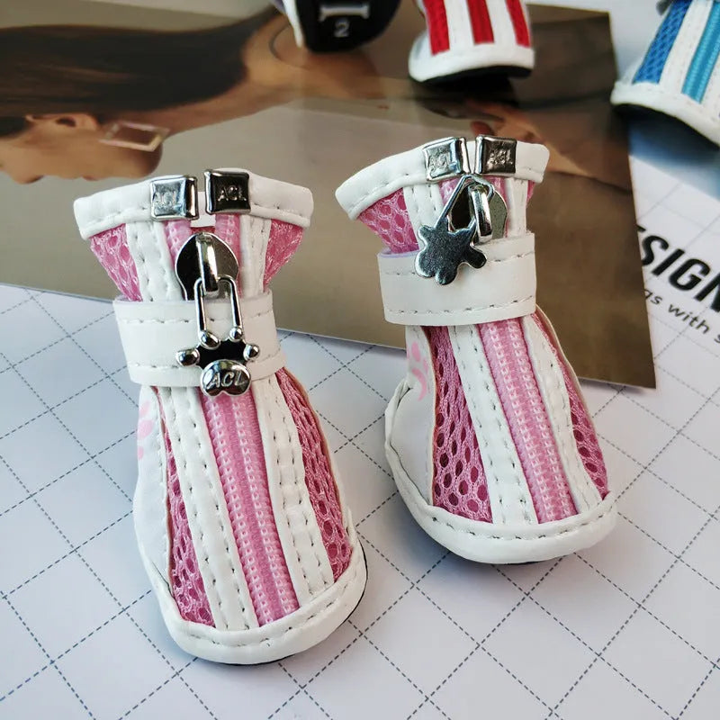 Four blue cloth dog shoes for small dogs with front zipper closure on a white background.