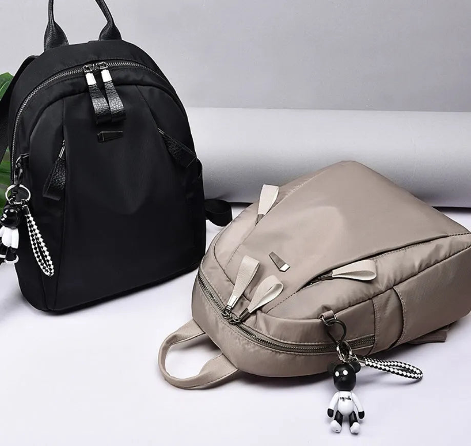 Medium Oxford cloth rucksack showing internal phone and ID compartments with dual straps