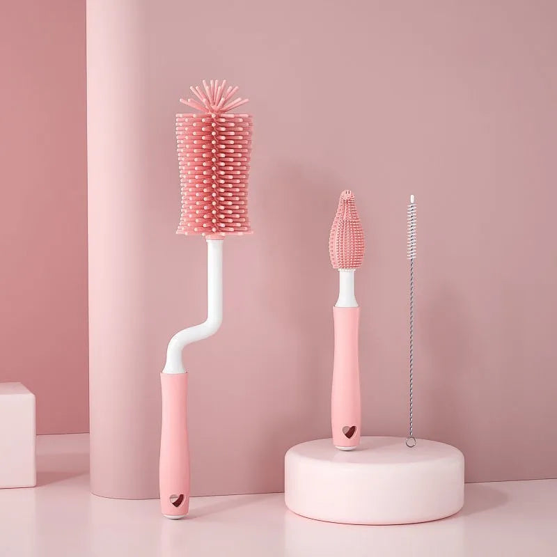 Three-piece baby bottle cleaning brush set with silicone bristles and a straw cleaner in assorted colours.