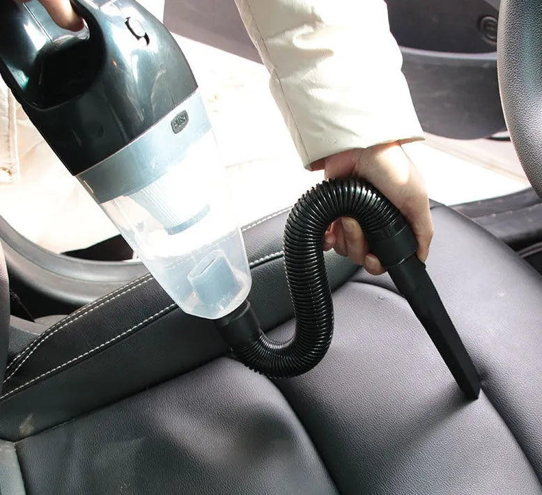 Orange, black, and blue handheld 12V car vacuum cleaner with nozzles and long power cord.
