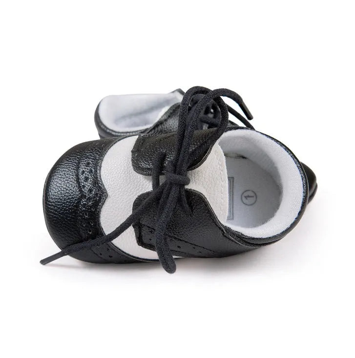 Vintage baby shoes with soft soles in light brown colour showing synthetic leather upper
