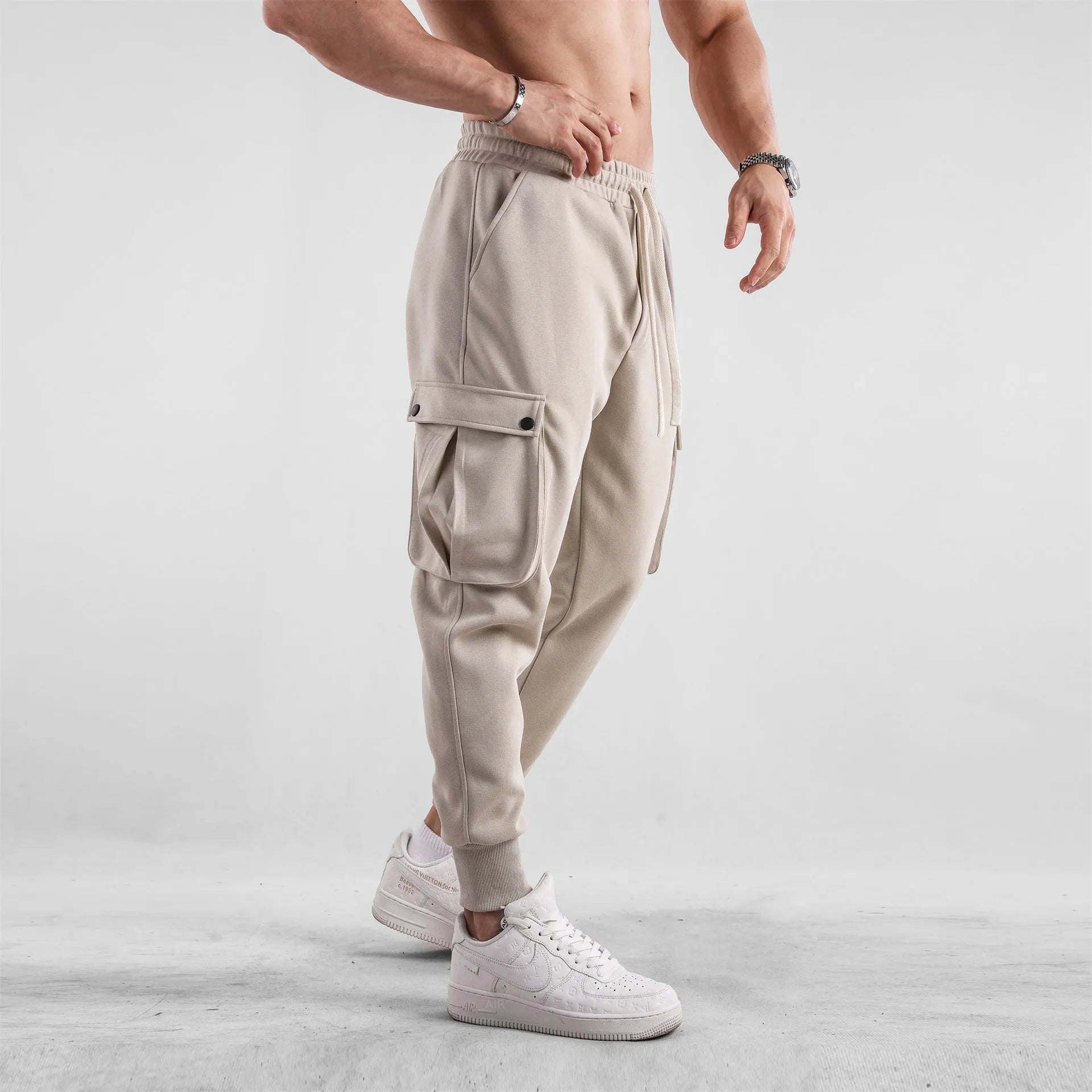 Men's loose light gray cotton trousers with ankle-tied cuffs and multiple pockets