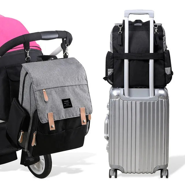 LAND Mommy large grey Oxford cloth diaper backpack with changing mat, showing front compartments.