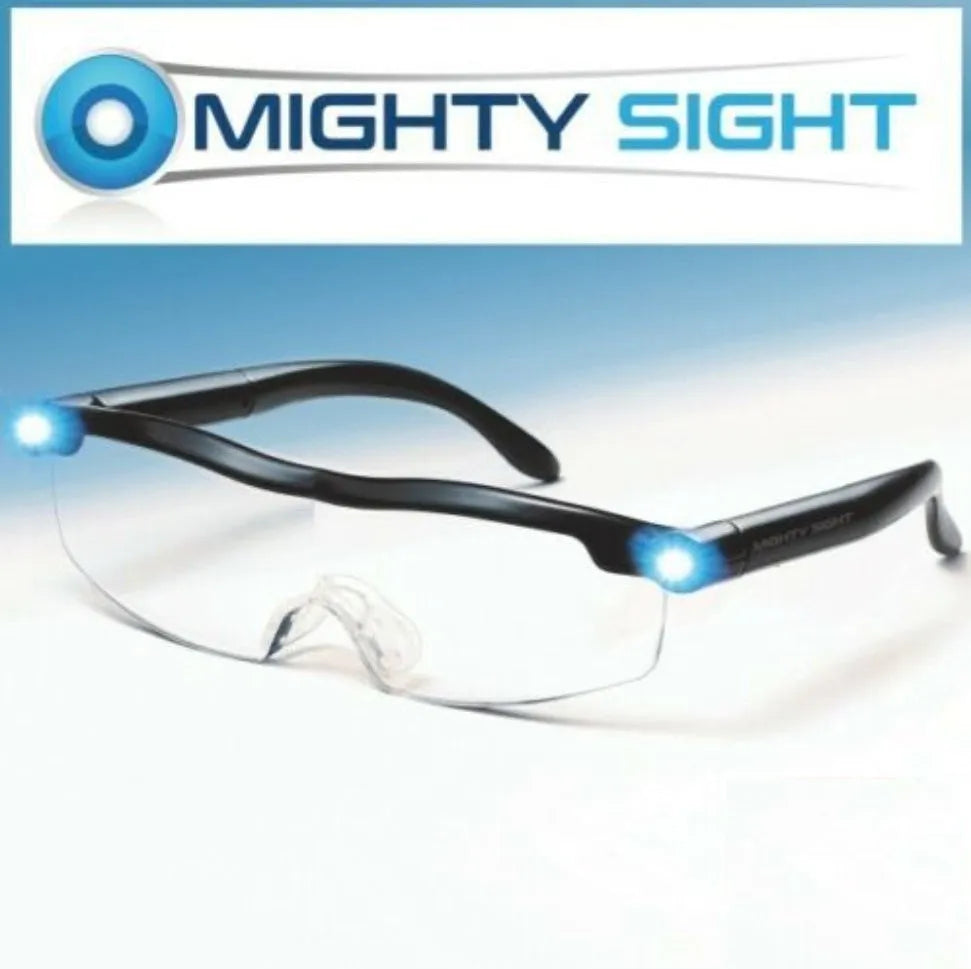 Transparent black USB LED reading glasses with integrated lighting, shown on reading material