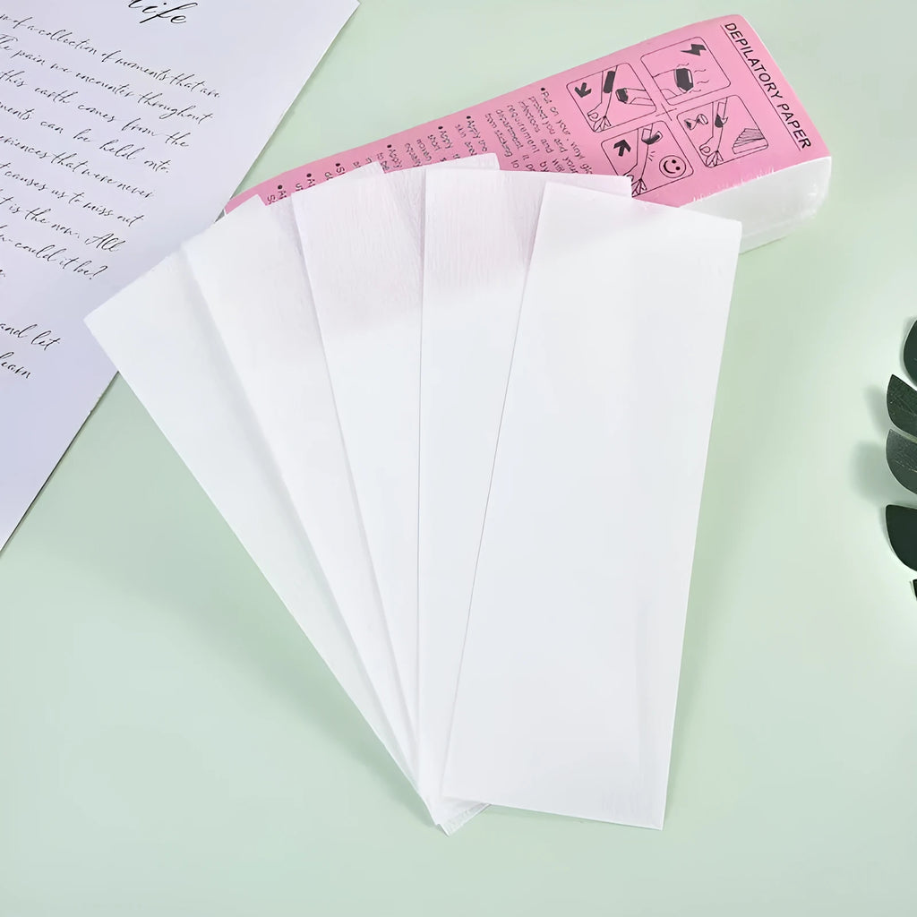 A pack of soft, white non-woven fabric hair removal wax paper strips.