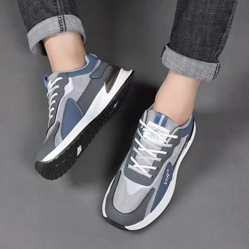 Men's colour block mesh running sneakers in black, grey, and white on a plain background.