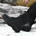 Men's beige cowhide hi-top hiking shoes with a platform sole on a rocky outdoor background.