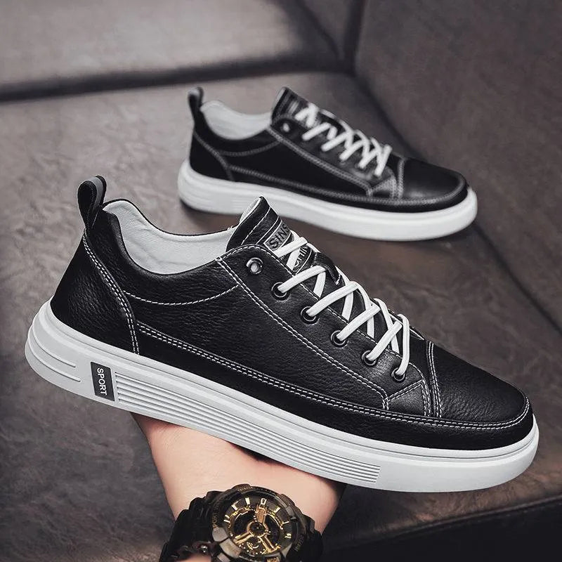 Men's white casual shoes with round toe and flat low heel on a plain background