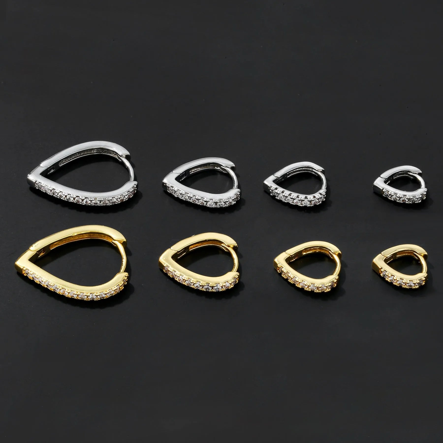 Geometric heart-shaped copper ear clip with electroplated gold finish, clip-on back visible
