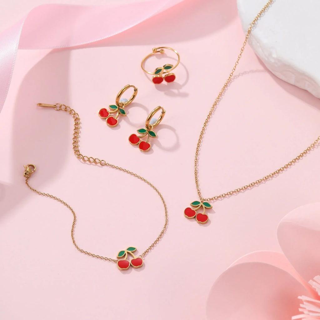 Cherry jewellery set with stainless steel necklace, bracelet, earrings, and ring featuring geometric shapes and 18K plating