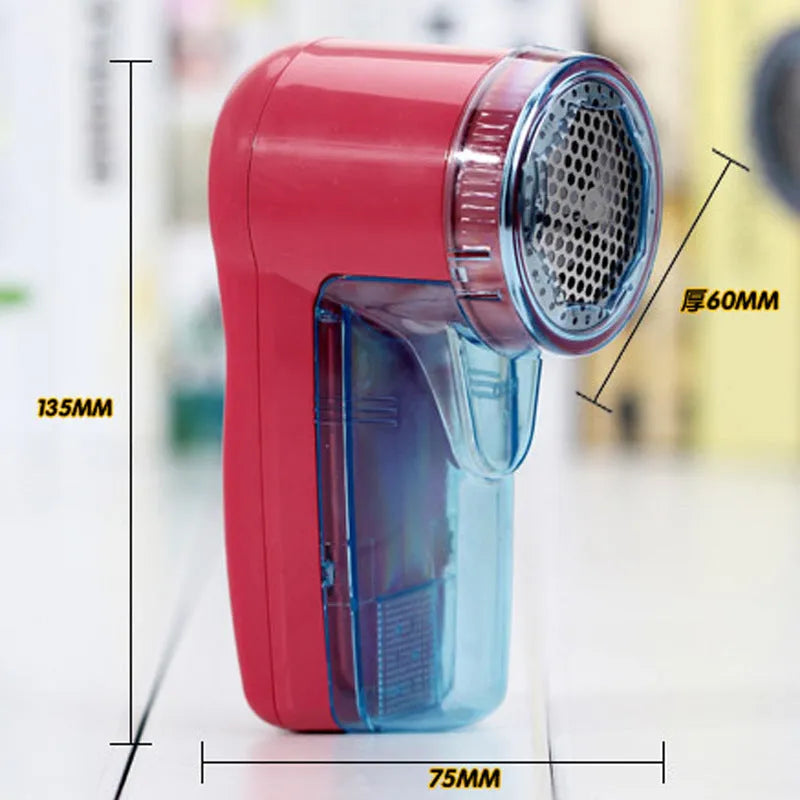 White portable electric lint remover for clothing, showing compact size and USB-C charging port.