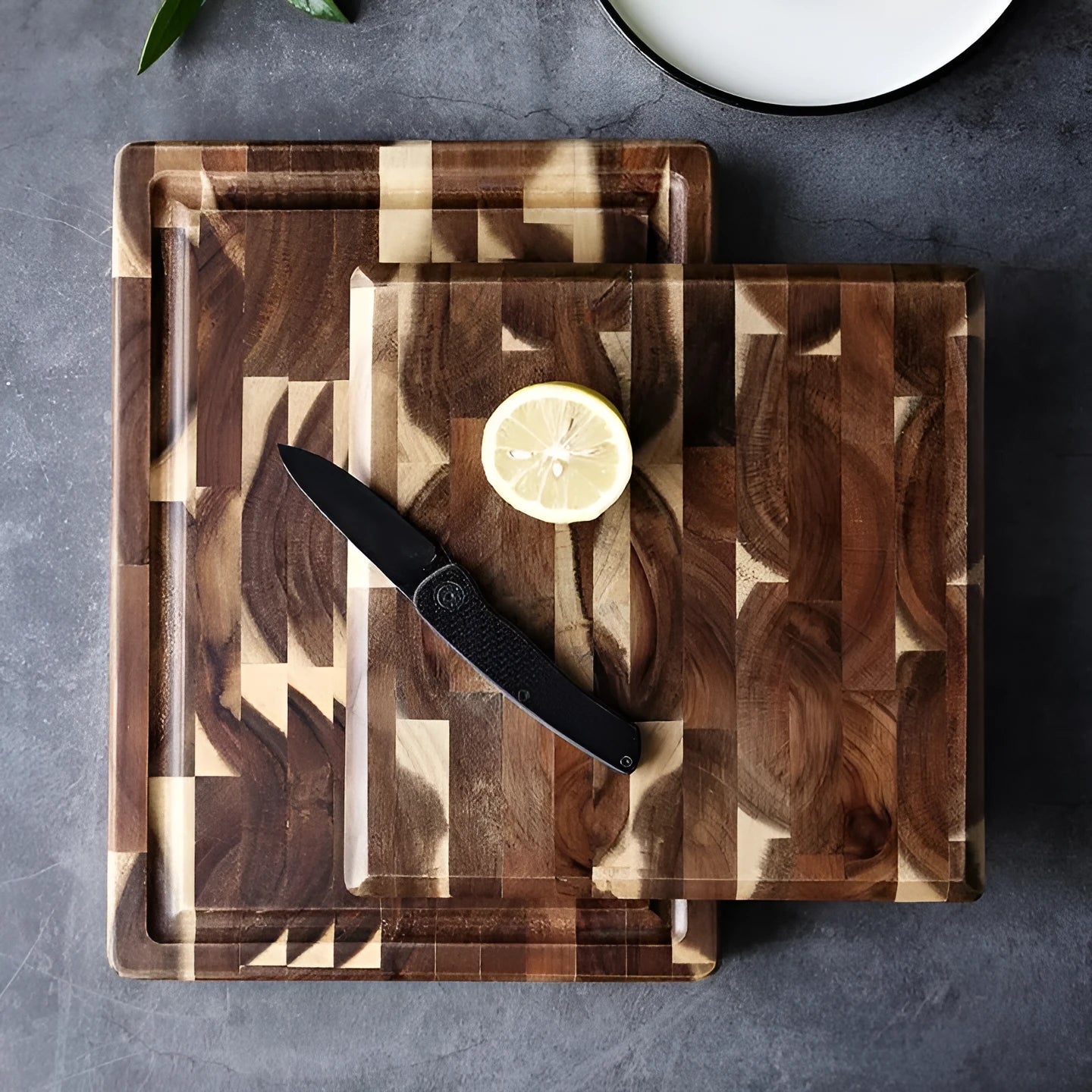 Brown acacia wood parquet cutting board with 3cm thickness on kitchen counter