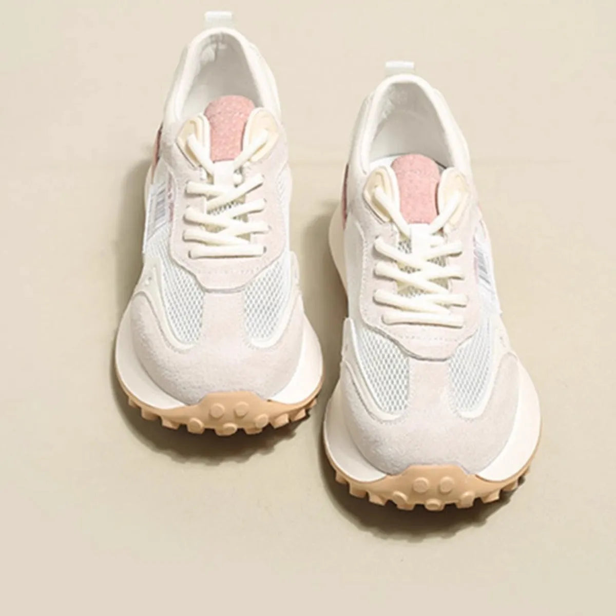 Women's low-top retro sneaker in grey with round toe, rubber sole, and mesh lining.