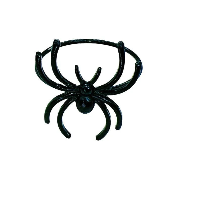 Set of six black alloy napkin rings with spider design for Halloween table decoration.