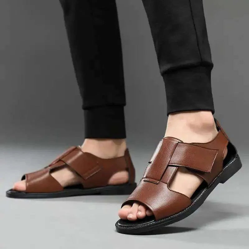 Men's black and brown Roman-style open-toe sandals with a leather upper and rubber sole.