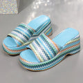 Women's beige wedge sandals with blue wave print design, fish mouth toe, and a thick rubber sole.