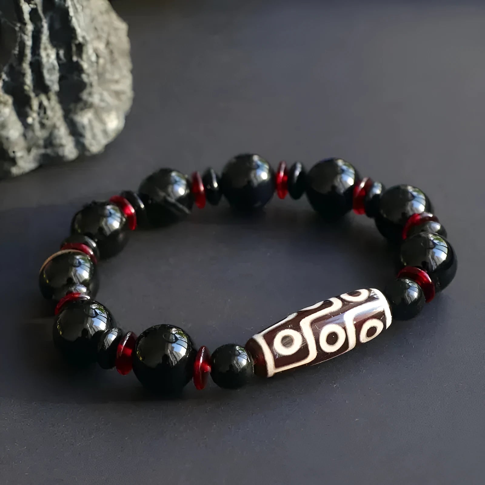 Black agate dzi bead bracelet with geometric pattern and hand-woven construction