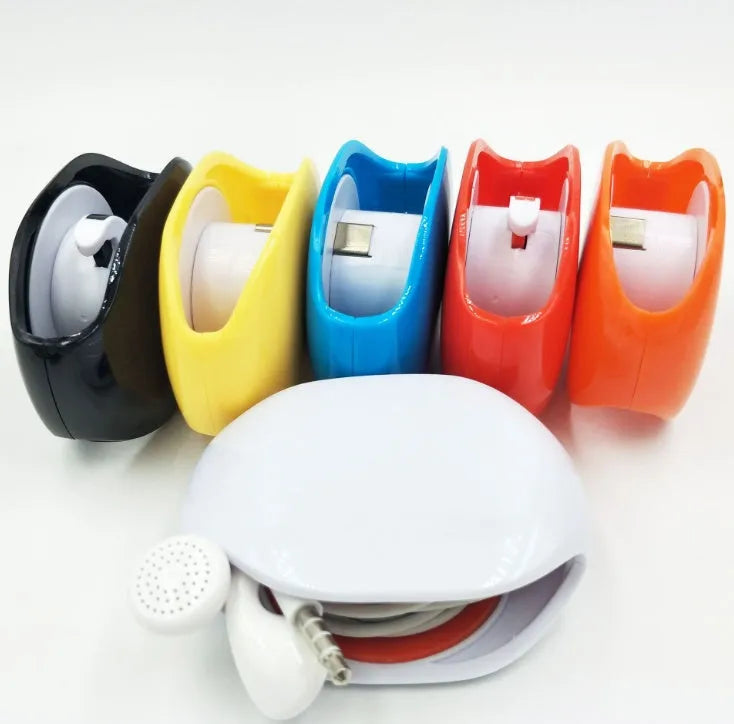 Automatic earphone retractor winder in black with extended cable showing push-type mechanism