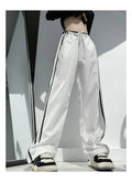 Women's navy blue loose straight trousers with white ribbon parallel bar waistband detail