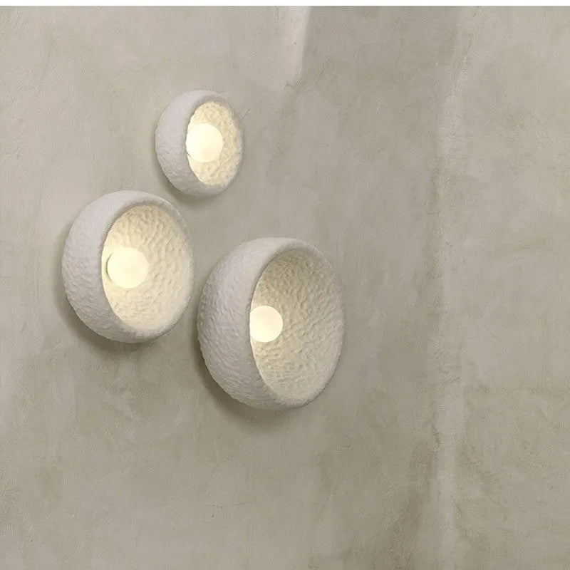 Japanese-style wall lamp with resin shade in three diameter sizes on white wall