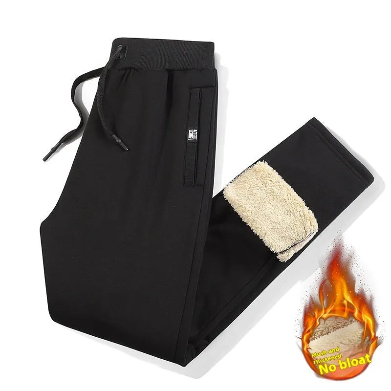 Grey fleece-lined men's oversized track pants with elastic waistband laid flat.