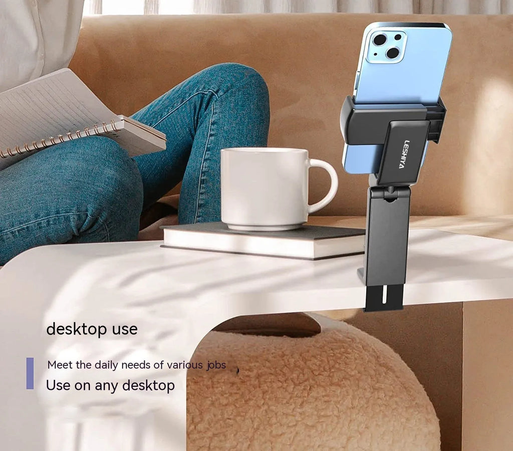Black foldable rotating phone holder holding a mobile phone upright on a desk.