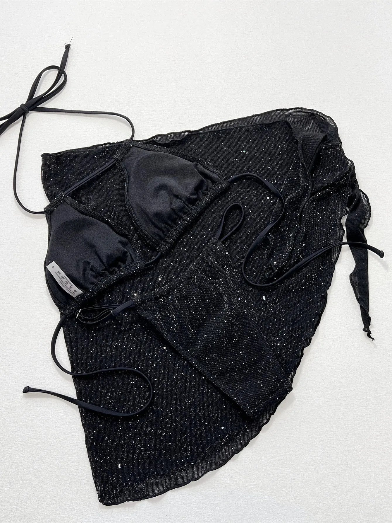 Black three-piece bikini swimsuit set showing separate top and shorts on mannequin