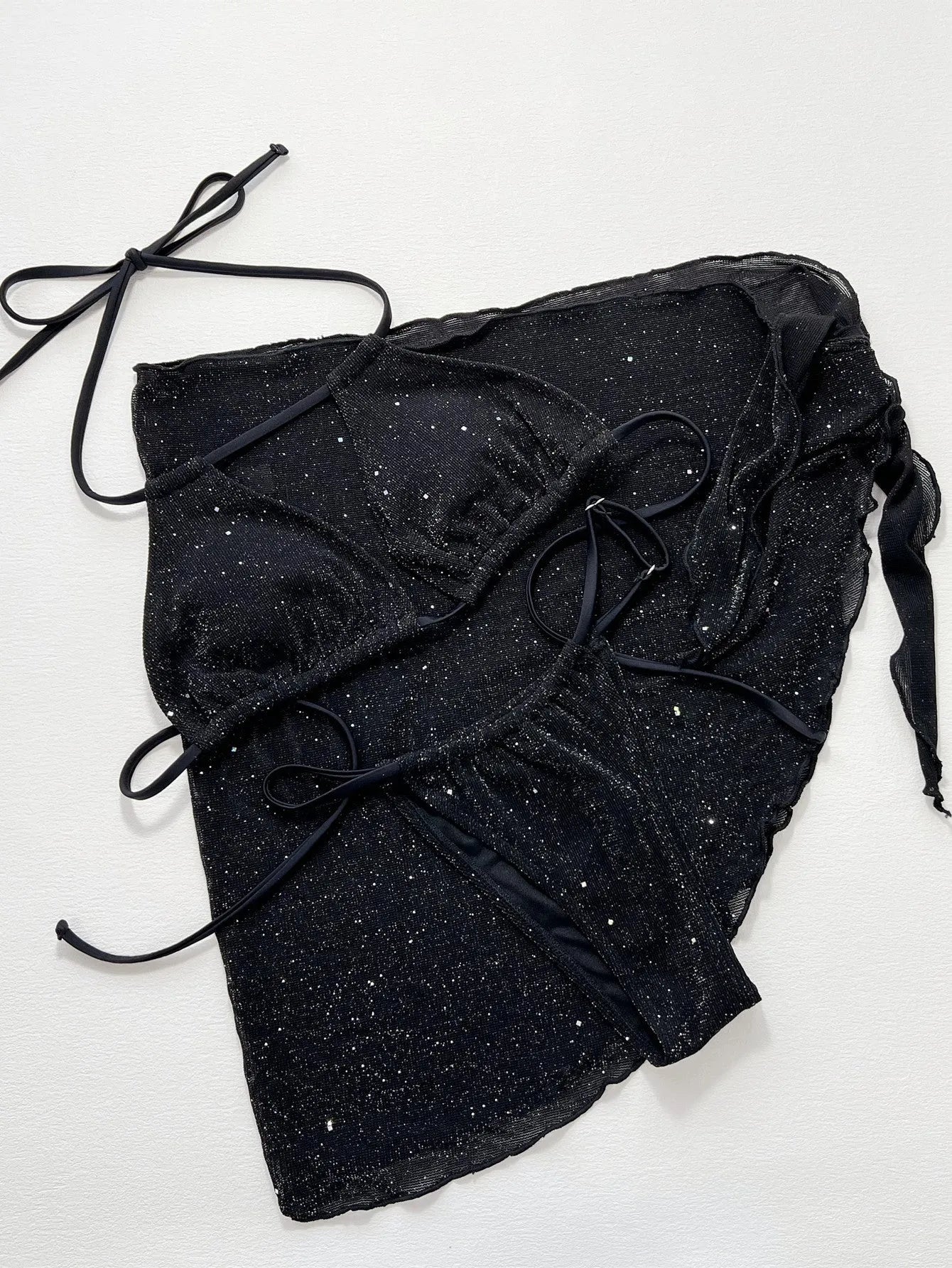 Black three-piece bikini swimsuit set showing separate top and shorts on mannequin