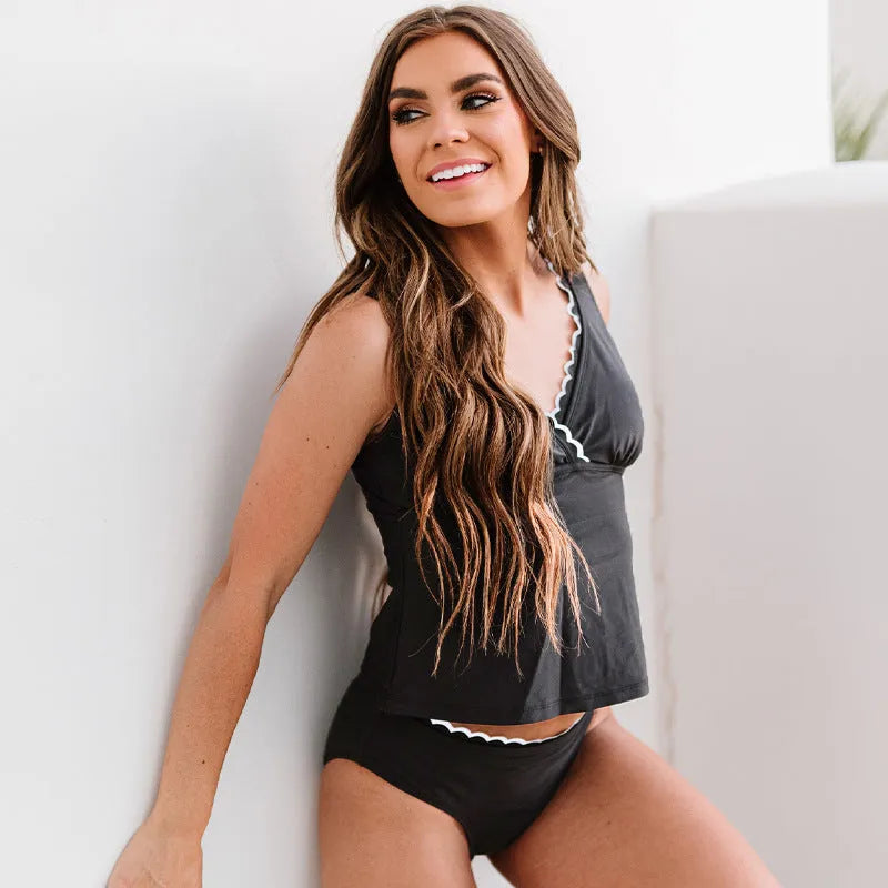Black solid colour women's two-piece bikini swimsuit on a white background.