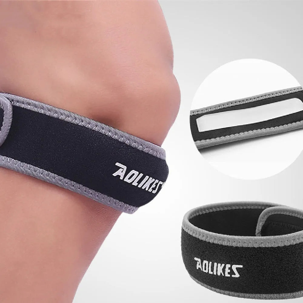 Black and grey adult patellar retinaculum knee brace for sports support.