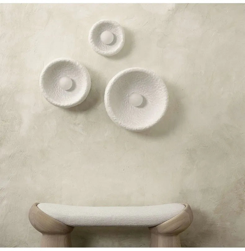 Japanese-style wall lamp with resin shade in three diameter sizes on white wall