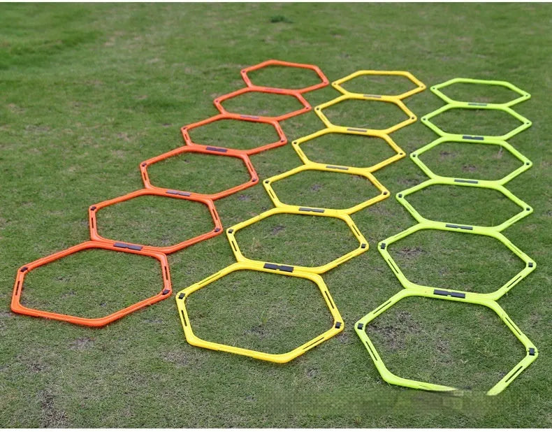 Set of six foldable hexagon football agility training rings in yellow green and orange plastic