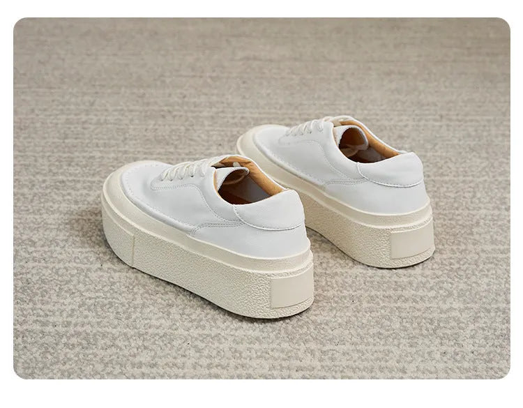 Women's black platform casual board shoes with embossed cowhide upper and round toe design