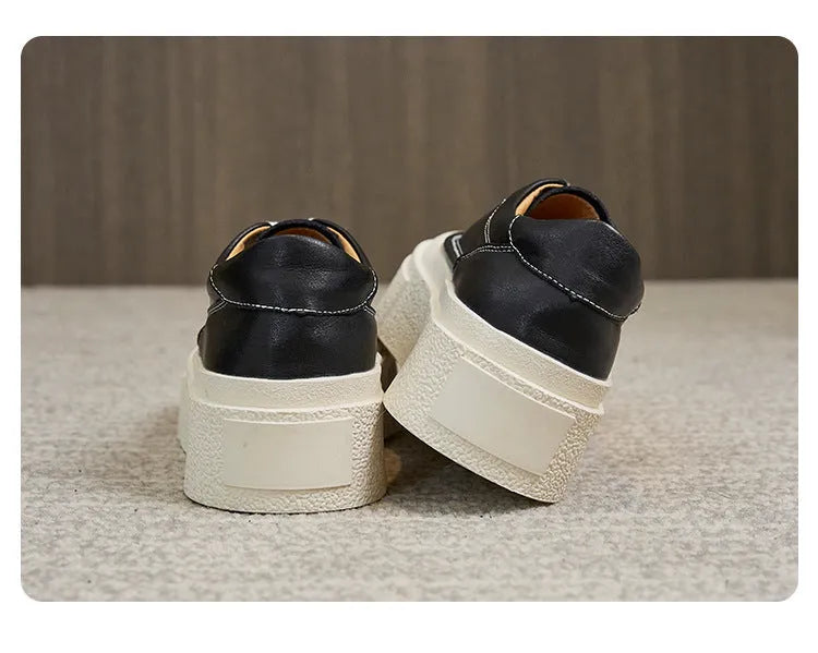 Women's black platform casual board shoes with embossed cowhide upper and round toe design