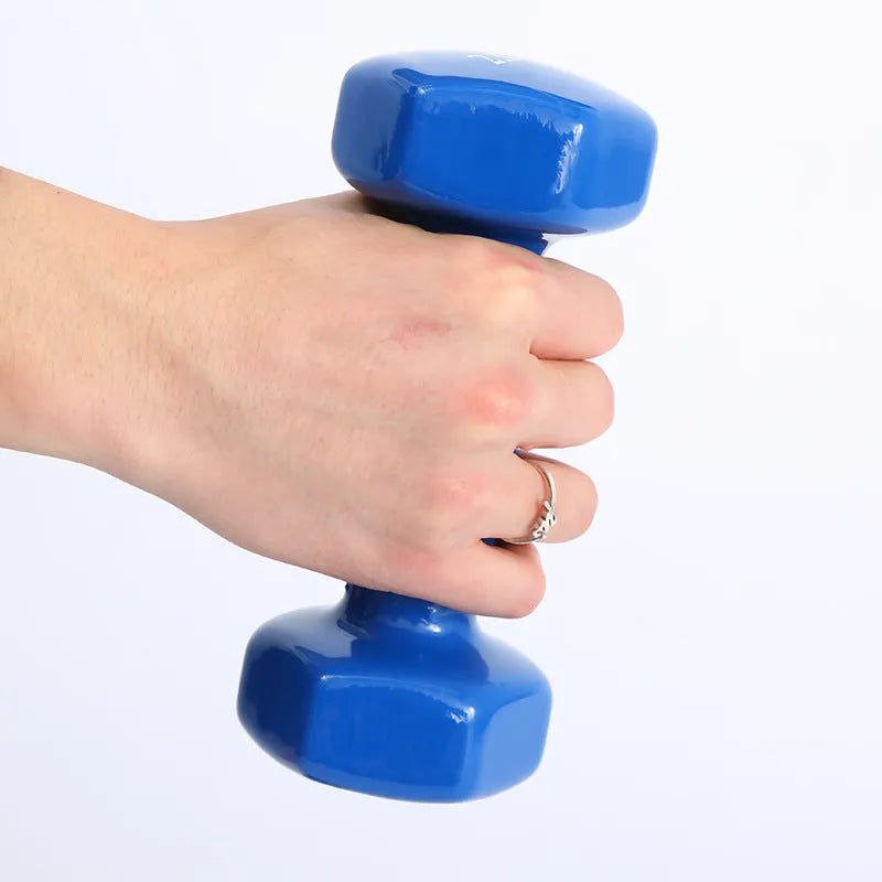Set of bright red and blue plastic fitness dumbbells on a light floor.