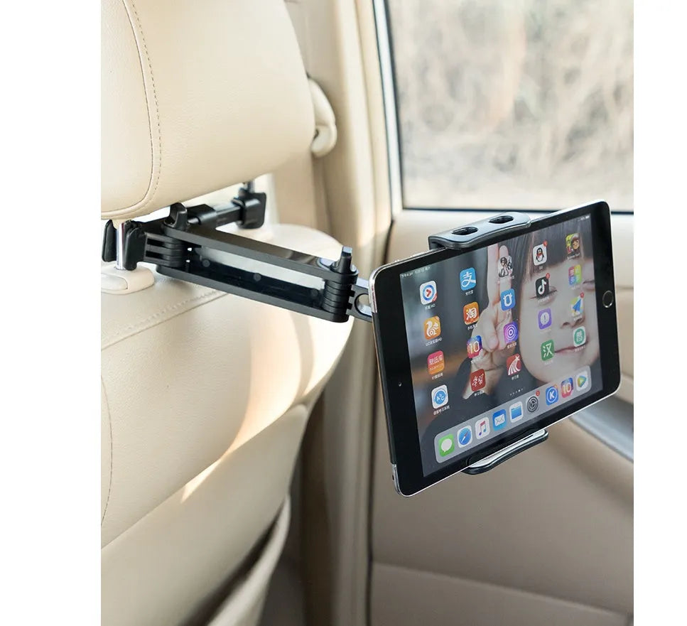 Black car phone holder mounted on vehicle rear seat base holding tablet for navigation