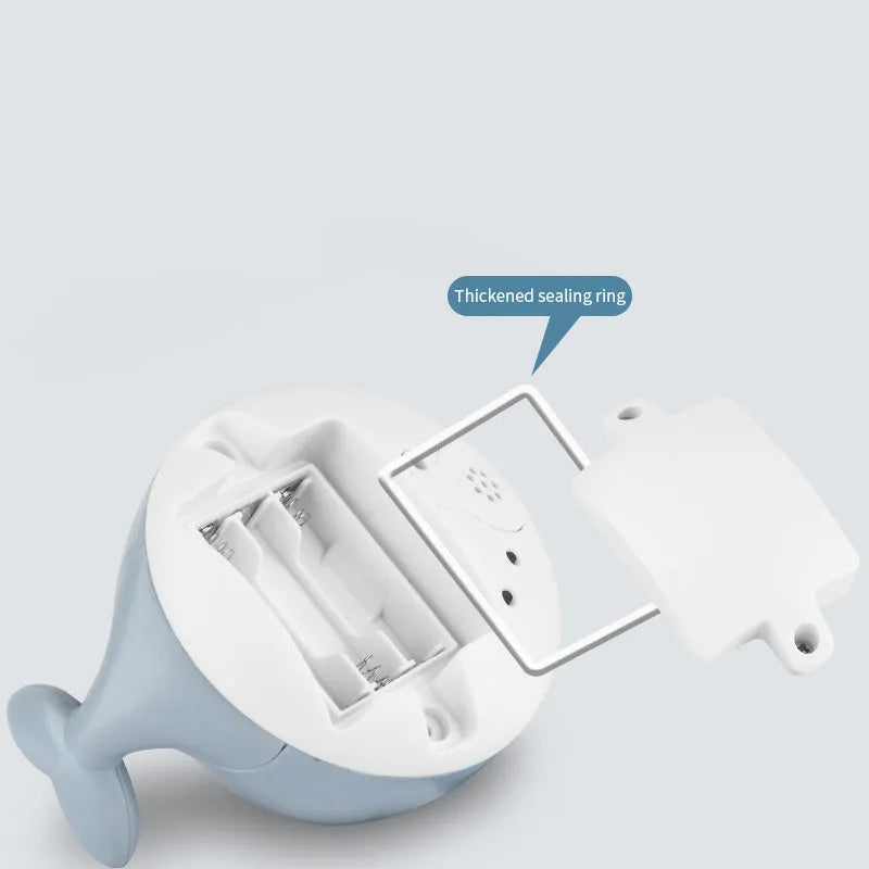 White and blue whale-shaped electric bath toy with water spray fountain and LED lights