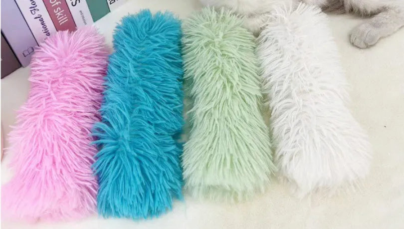 Soft plush cat toy pillow in blue, green, pink, or white, measuring 27cm long by 10cm wide