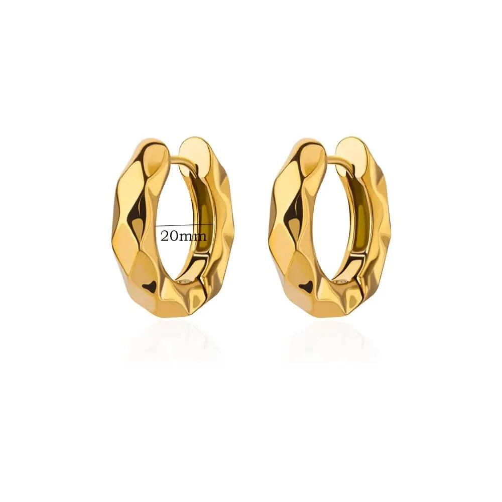 Close-up of women's geometric butterfly drop earrings with heart, star, and bow shapes in copper.