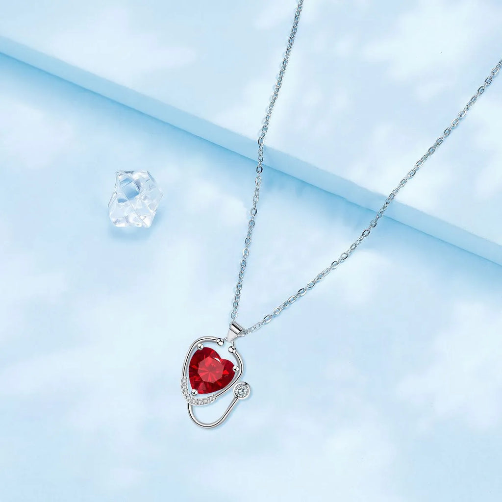 Women's fashion necklace with stethoscope, wings, and cross design in red diamond electroplated copper