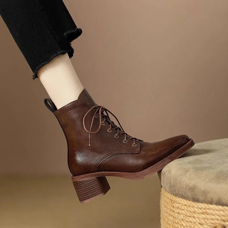 Women's black pointed-toe short ankle boots with a 5.5cm heel on a plain background.