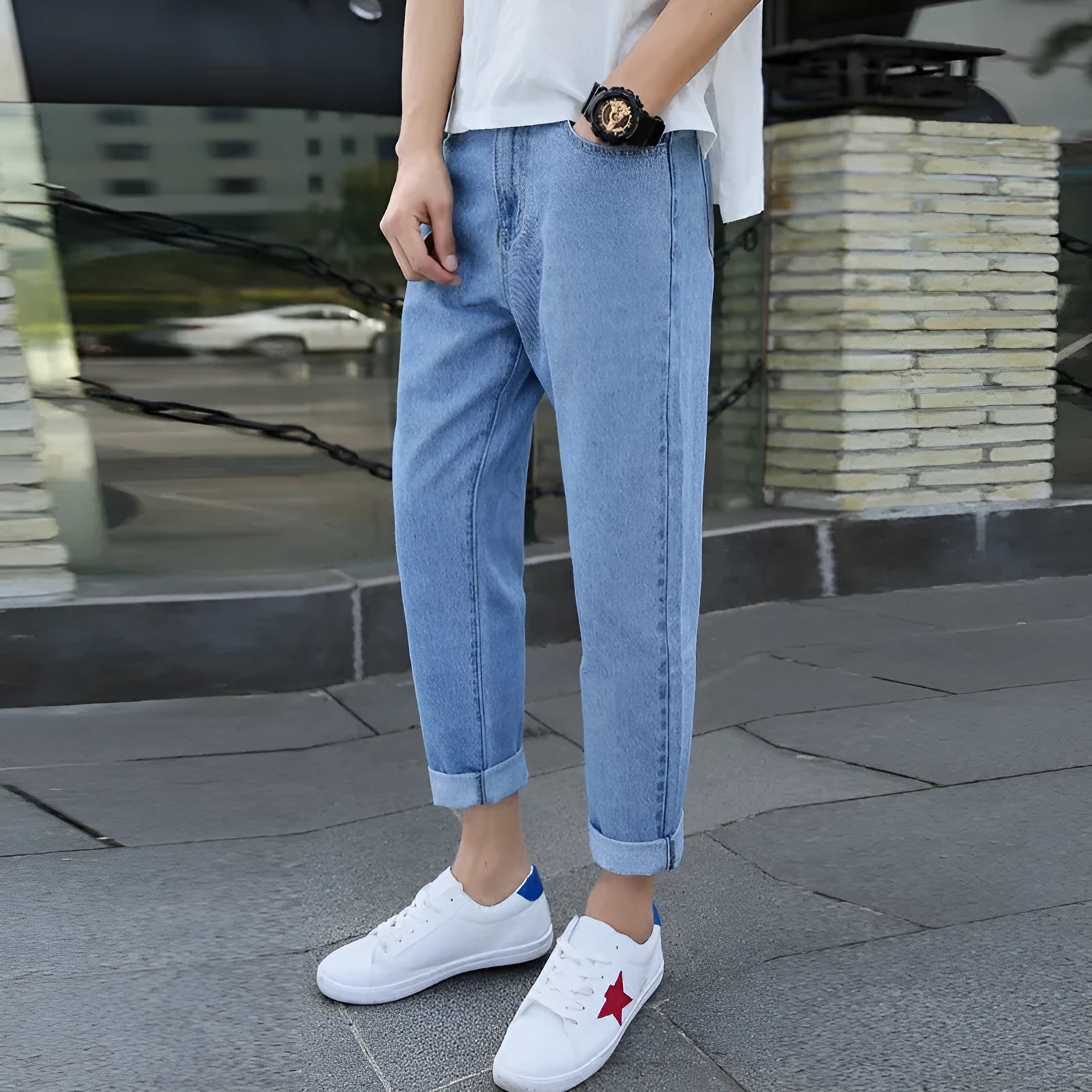 Men's loose straight leg blue cotton jeans with a college style on a casual background.