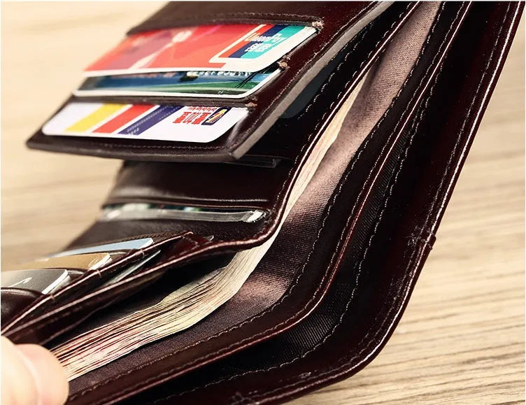 Men's leather wallet showing multiple internal compartments including card slots, coin pocket and photo window