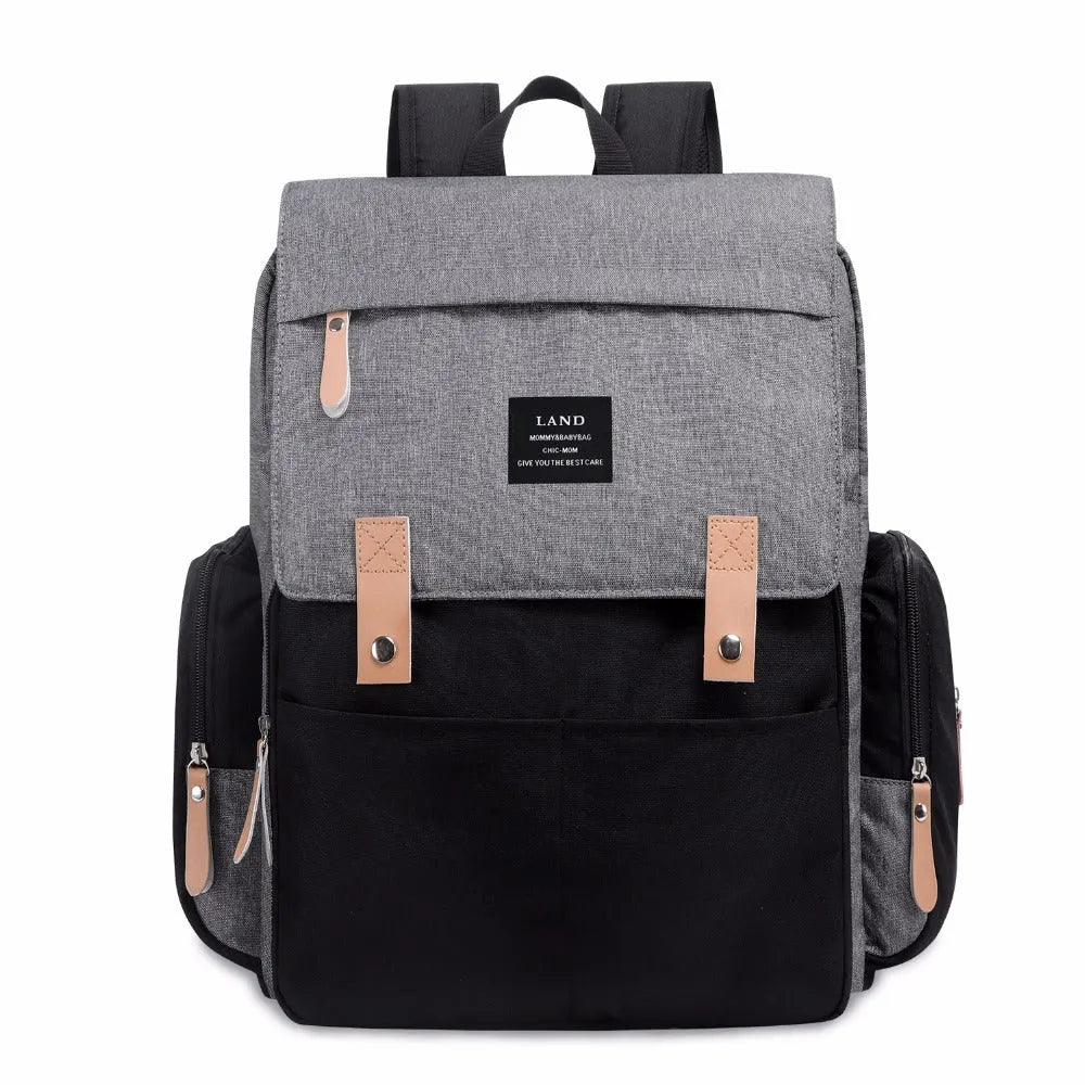 LAND Mommy large grey Oxford cloth diaper backpack with changing mat, showing front compartments.