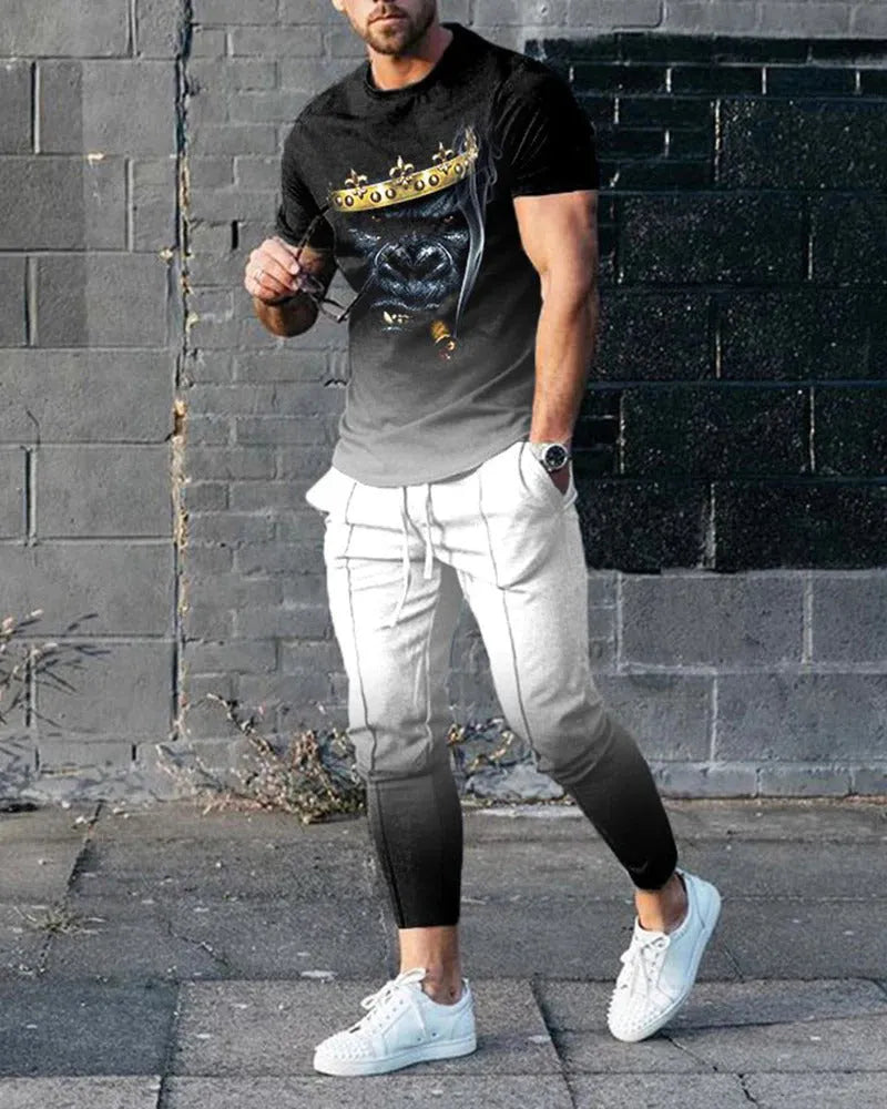 Man wearing a printed short-sleeve t-shirt and matching trousers from a cotton-like men's tracksuit set.