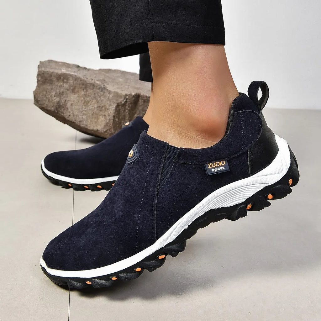 Men's grey PU slip-on overshoes with a round toe and rubber sole, shown on a foot.