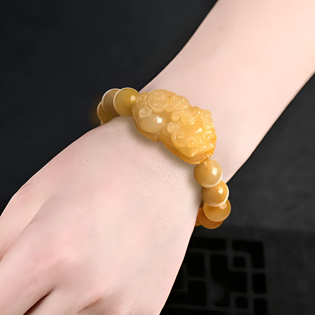 Carved Jinsi Jade money bracelet in Golden Thread Jade colour showing texture and bead detail.