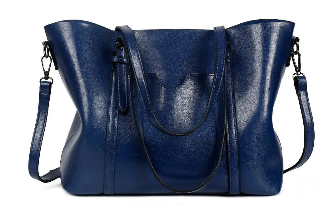 Retro-style brown PU messenger bag for women shown with shoulder strap, displaying its large main compartment.