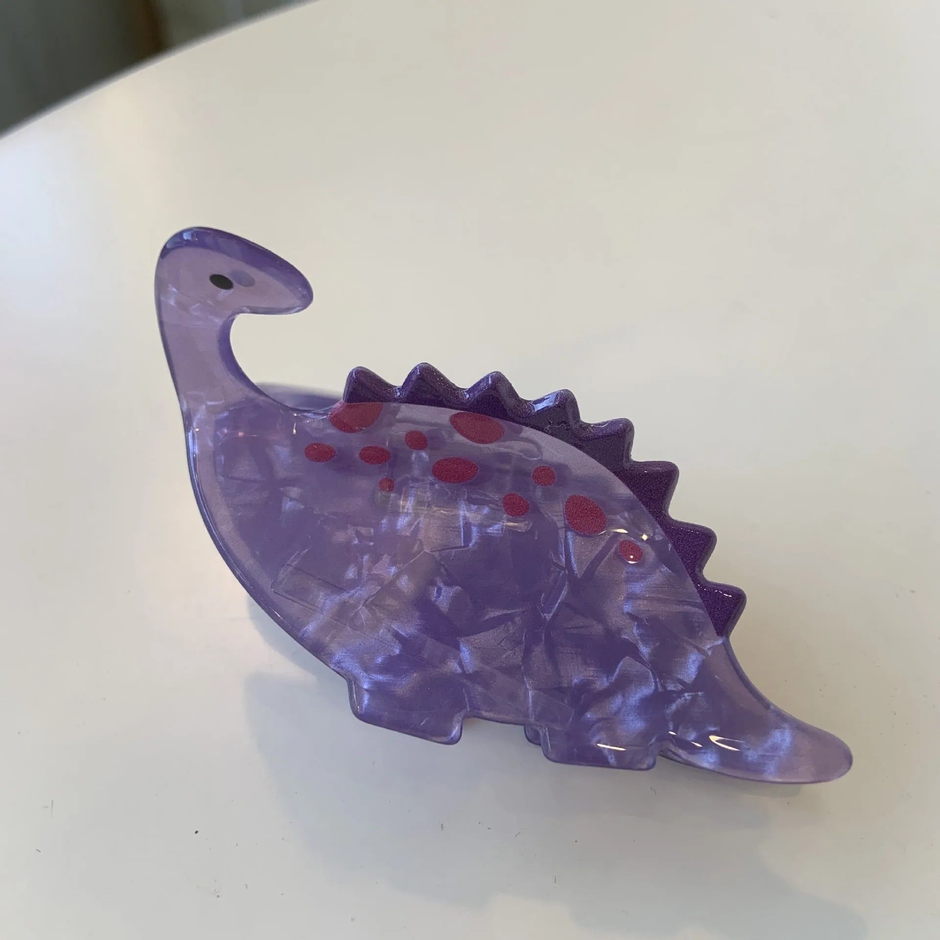 Colourful dinosaur acrylic jaw hair grip clip showing six design variations